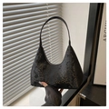 Detail of black snake-textured hobo bag showing faux python leather and metal zipper - Black