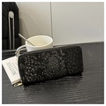 Detailed close-up of a black snakeskin embossed long leather wallet with gold zipper - Black