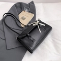 Black baguette shoulder bag featuring a white ribbon bow and minimalist flap design - Black
