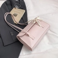 Elegant light pink shoulder bag with decorative ribbon bow and double straps - Pink