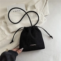 Minimalist black denim drawstring bucket bag with silver JINGPIN metal logo lettering - Black