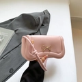 Pink leather handbag with golden bow accent and knotted shoulder strap design - Pink