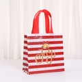 Detail of red striped holiday gift bag with golden bell decor and Joy text print - 9050-7; 20*9*9; Brand New Non-woven Fabric