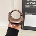 Chic laser acrylic dumpling bag with glossy finish and golden metal chain strap - Bronze