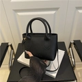 Chic black litchi textured leather handbag with DX logo and adjustable shoulder strap - Black