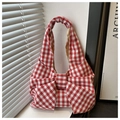 Detailed close-up of a red and white gingham tote bag with unique large bow design - Red