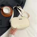 Minimalist beige nylon crossbody bag with adjustable strap and metal logo plaque - White