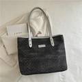 Black polka dot tote bag with silver handles and front leather patch detail - Black