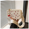 Detail of white cherry print crossbody bag with golden hardware and cherry charm - White With Pendant