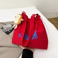 Red canvas tote bag with blue Beach text, drawstring closure, and toast plush pendant - Red with Pendant