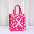 Pink non-woven gift bag with white breast cancer awareness ribbon print and handles - Classic Center Ribbon (5049-3) / 23x22x11cm