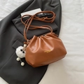Brown pleated dumpling bucket bag with gold lettering and a white plush toy charm - Brown (With Pendant)