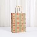 Close-up of Christmas kraft paper gift bag with festive candy cane and snowflake patterns - Vintage Candy Cane And Berry Pattern (047-8)