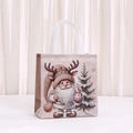 Detail of Christmas non-woven gift bag with Santa Claus print and sturdy white handles - Santa and Christmas Tree Pattern (5044-2) / 23x22x11cm