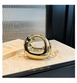 Close-up of polished gold crescent bag with smooth metallic finish and snake chain - Gold