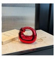 Detail of red metallic acrylic mini bag with gold chain strap on marble surface - Red