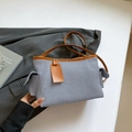 Blue-grey twill shoulder bag with brown leather trim and matching decorative tag - Blue