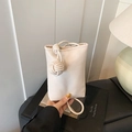 Chic cream mini bucket bag with woven knot detail and lychee grain texture strap - White