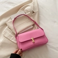Barbie pink leather shoulder bag with gold U-shaped buckle on beige blazer jacket - Pink