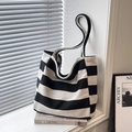 Large black and white striped canvas tote bag for commuting and travel on a white windowsill - Black