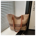 Stroh-Stofftasche mit braunem Spitzenbesatz und Lederriemen im sanften Fensterlicht - Khaki
