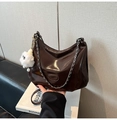 Detail of dark brown patent leather hobo bag with silver chain and plush charm - Coffee (With Pendant)