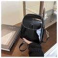 Detail of black glossy mini phone bag featuring contrast white stitching and gold hardware - Black