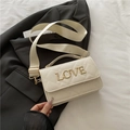 Beige quilted barrel crossbody bag with gold LOVE lettering and wide shoulder strap - White