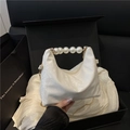 White snakeskin embossed handbag with large pearl handle and gold chain strap - White