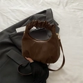 Dark brown half-moon crossbody bag with pleated handle and matte finish texture - Brown
