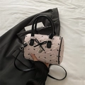 Pink seersucker Boston bag with black bow accents and a heart pendant charm - Pink