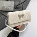 Creamy white shoulder bag with marble texture and a large silver butterfly buckle - White