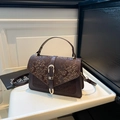 Vintage dark brown crossbody bag with snake texture and gold horseshoe buckle details - Brown
