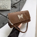 Quilted dark brown leather crossbody bag with silver butterfly buckle and chain strap - Brown