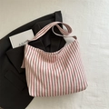 Large red and white striped canvas tote bag on black blazer with a minimalist design - Pink