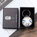 Detailed close-up of a FIFA World Cup soccer ball keychain in a premium black gift box - Style G Soccer Ball Keychain With Gift Box