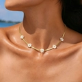 Detail of gold snake chain necklace with five white daisy charms in shell texture - Blade Chain + 5 Daisies