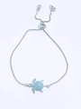 Detail of adjustable box chain with turtle charm featuring blue opal-like stone inlays - Silver-Sky Blue