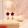 Christmas star earrings with red flocking finish and golden bell pendants on a smile rack - Red Flocking Star Bell Style (2623)