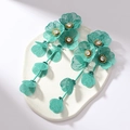 Detailed macro of mint green flower earrings with metallic mesh petals and crystal center - Green