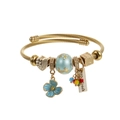 Detail of gold cable wire open bangle with blue enamel flower and heart charms - Blue Flower Style (B)