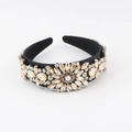 Macro detail of Baroque style headband featuring champagne crystals and a pearl sunflower - Black Matte Champagne Clear Rhinestone (G)