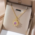 Gold rotating sunburst pendant necklace with a purple center stone and zircon stones - Purple Sunflower Style (X0442)