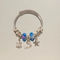 Detail of silver cable bracelet with sea turtle dolphin charms and blue glass beads - Blue Ocean Creature Bracelet