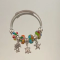 Detailed view of ocean-themed charms featuring turtle, starfish and palm tree on a bracelet - Colorful Palm Tree Ocean Bracelet
