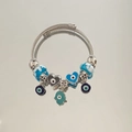 Detail of multi-layer steel bracelet with blue Hamsa hand and Evil Eye charms - Double Heart All-Seeing Eye Bracelet