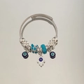 Detail of Hamsa Hand and Evil Eye charms on a beaded twisted rope bangle bracelet - Green Zirconia All-Seeing Eye Bracelet