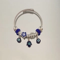 Detailed shot of silver cable bracelet with blue Evil Eye and Hamsa Hand charms - Blue Zirconia All-Seeing Eye Bracelet