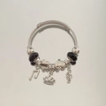 Silver beaded bracelet with music note and heart charms in a double cable design - Black Crown Note Bracelet