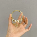 Golden wire wrap bracelet with moon and star pendants and white porcelain beads - Wonderland Star Moon Bracelet